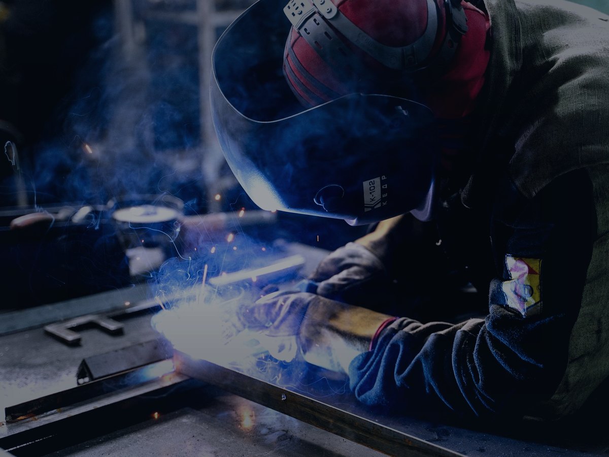Fabrication welding on steel bar at a workshop bench