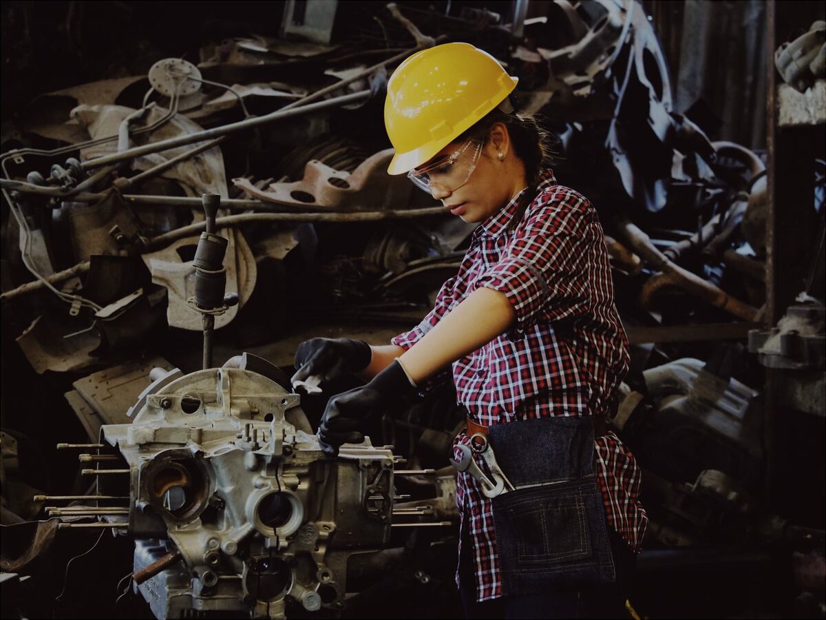 Mechanic working on a gearbox casing in a workshop